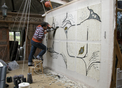 artist tufting wool rugs on frame